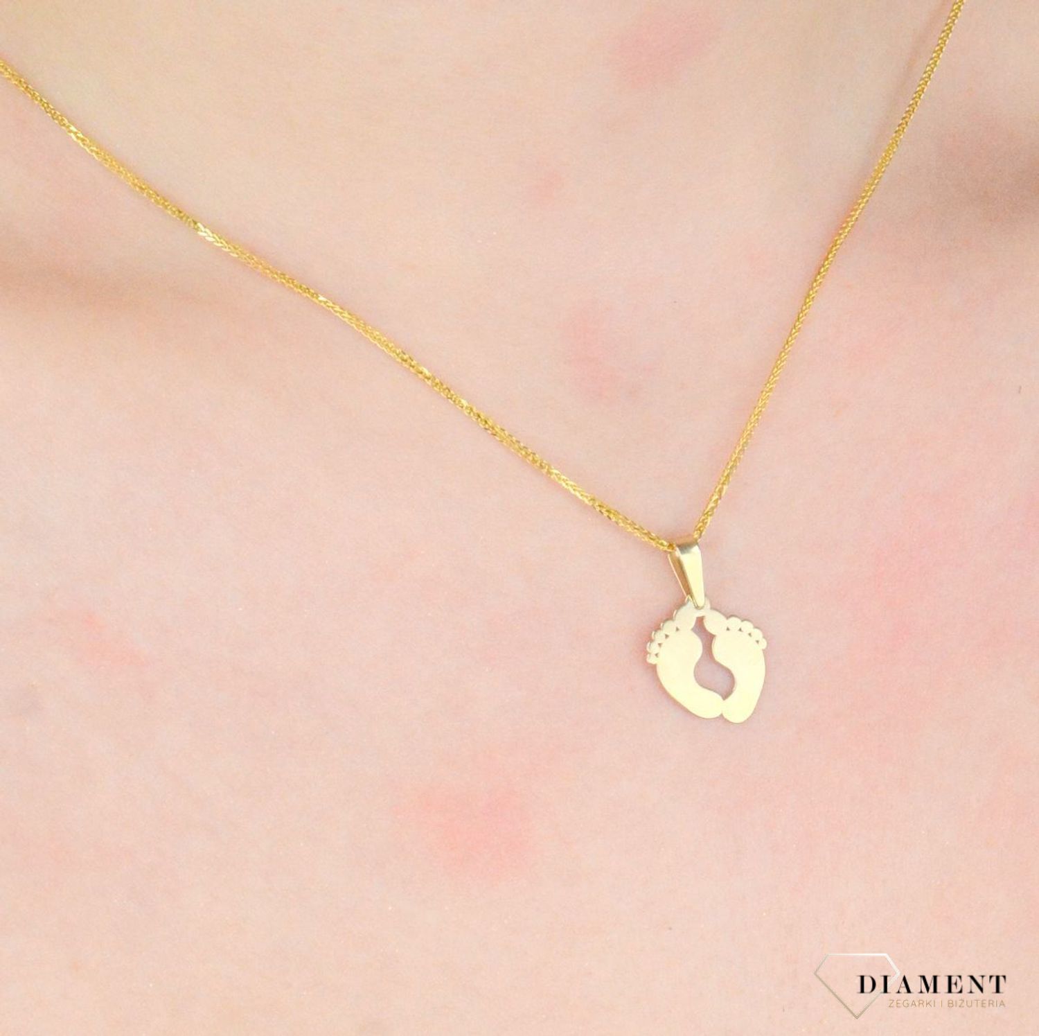 Zawieszka złota damska stopy stópki próba 375, ZA 5602 375  Piękny, złoty wisiorek o ciekawym wzorze wykonany z żółtego złota. Zawieszka w formie stópek. Wisiorek został wykonany z wysokiej jakości złota próby 375.1.jpg